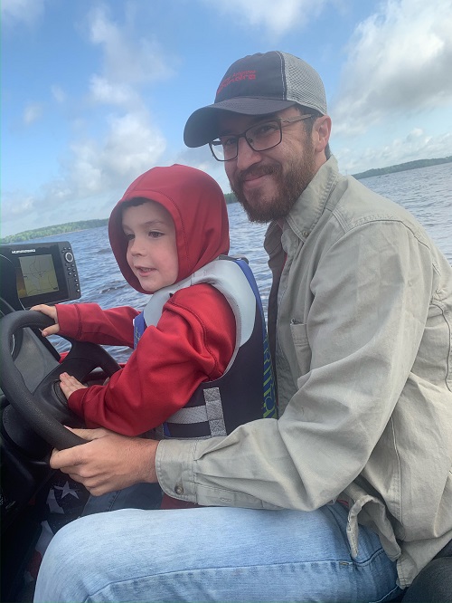 Man and Boy driving boat